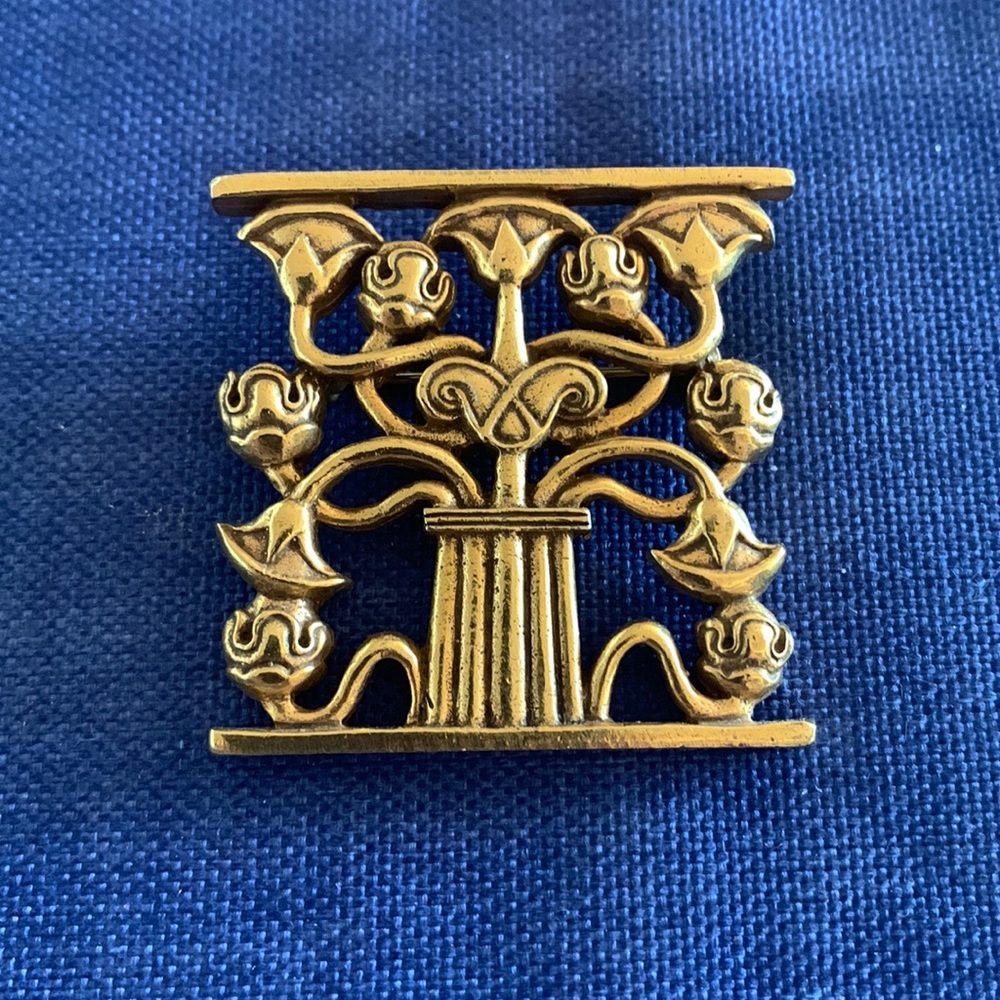 MMA Brooch, stamped mma 1995.  Brass. 1.75” by 1.75”.